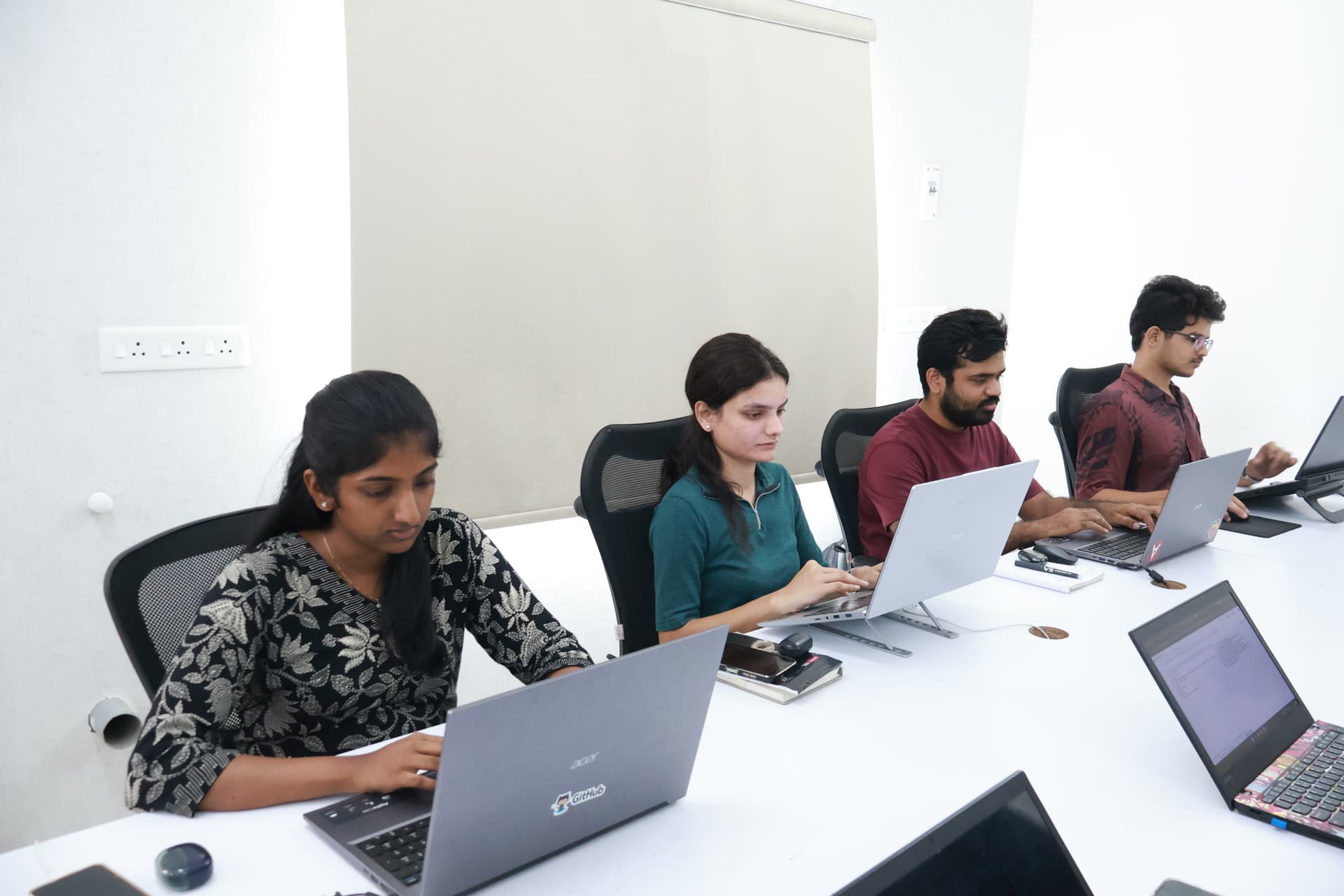 HIT Foundation Wall of Fame achievers celebrating in a modern innovation workspace